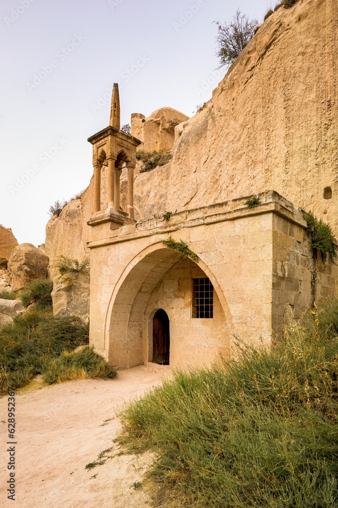 Majestic old mosque with majestic mountains in the background in Cappadocia, Turkey