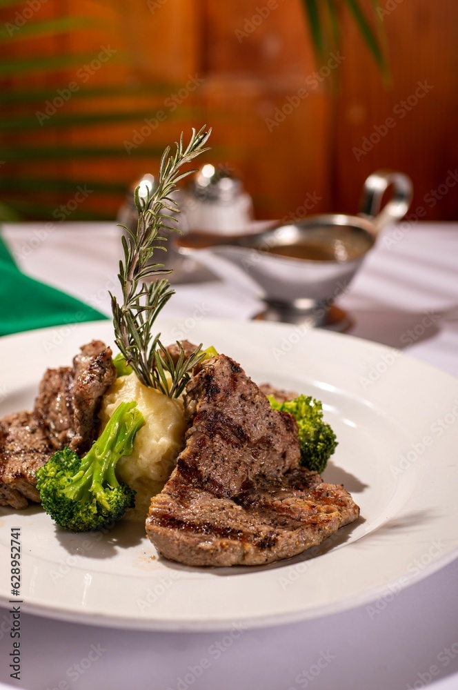 Delicious meal of meat and broccoli with mashed potatoes on a white plate, ready to be enjoyed Delicious meal of meat and broccoli with mashed potatoes on a white plate, ready to be enjoyed