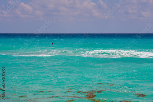 Waves with foam on the Caribbean coast in Mexico. © Arthur