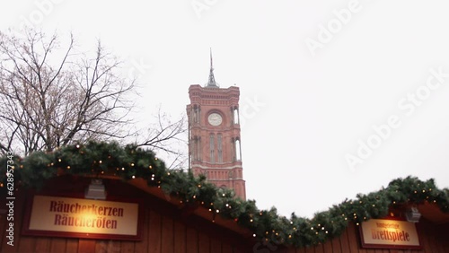 brick building, Rotes Rathaus, Red Town Hall. Christmas decorations displayed outside Red Town Hall, located in Berlin's Mitte district, in foreground there is shop that is decorated for the holidays