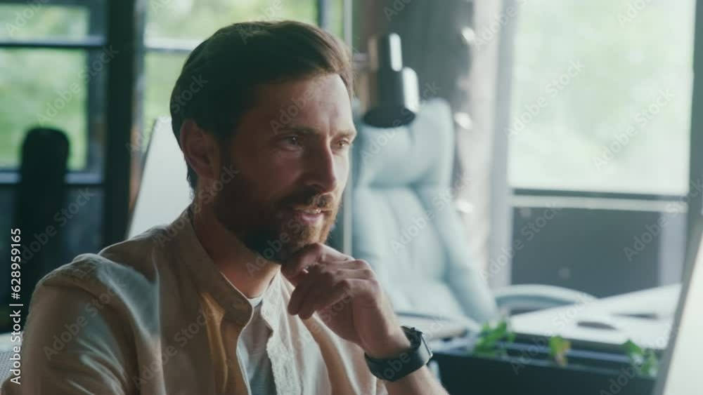 Handsome Caucasian man working in front of the computer at the office