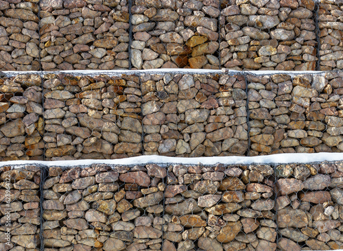 Vászonkép Gabions, mesh structures made of stones that strengthen the slopes, from the sliding of the ground