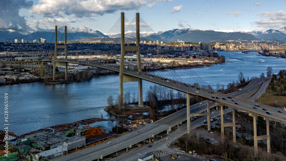 Aerial view of the Alex Fraser Bridge, with its long, arching over the Fraser River