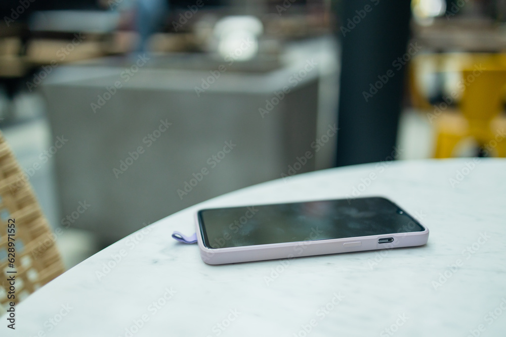 Smart phone on white rustic cafe table background. High quality photo Smart phone on white rustic cafe table background. High quality photo