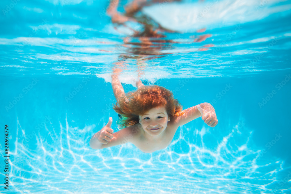 Summer kids in water in pool underwater. Child swim and dive underwater in the swimming pool.