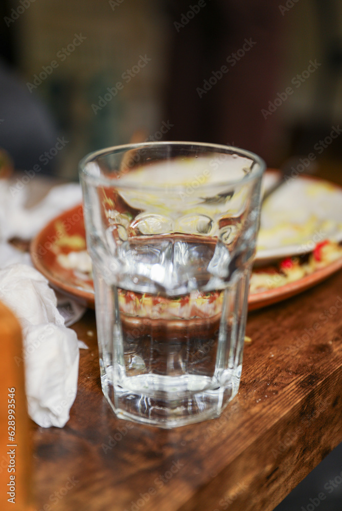 glass cup on a table, symbolizing clarity, transparency, and receptivity to new ideas and perspectives. Metaphor for openness glass cup on a table, symbolizing clarity, transparency, and receptivity to new ideas and perspectives. Metaphor for openness