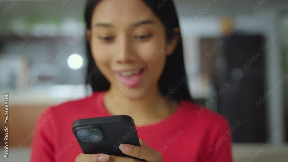 Close-up woman hand using phone in living room at home. She having chat with friend or chatbot in living room. Close-up woman hand using phone in living room at home. She having chat with friend or chatbot in living room.