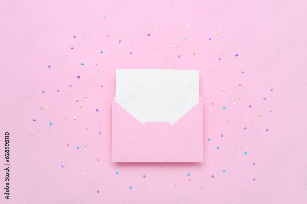Envelope with blank card and stars on pink background Envelope with blank card and stars on pink background