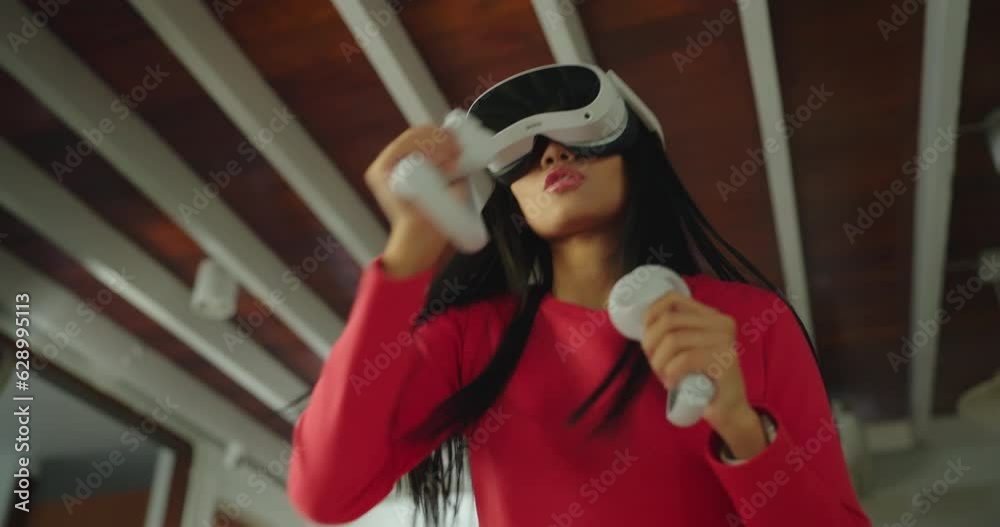Young asian woman playing boxing game and workout in VR Headset. Concept of activity in home. Young asian woman playing boxing game and workout in VR Headset. Concept of activity in home.