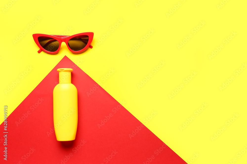 Sunglasses with bottle of sunscreen cream on color background Sunglasses with bottle of sunscreen cream on color background