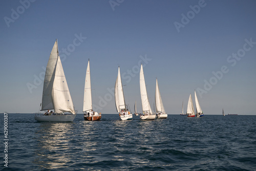 Sailing yacht regatta. Many sailing yachts in a row. sailing yachts under gennaker, speaker, genoa