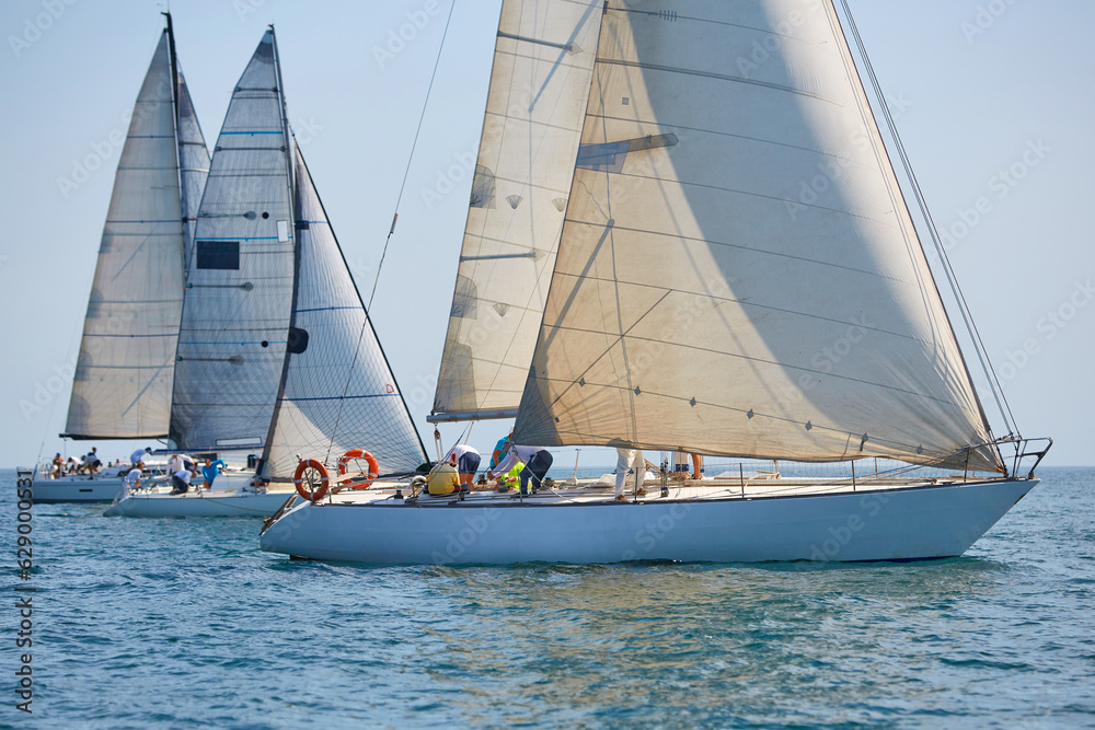 Sailing yacht regatta. Many sailing yachts in a row. sailing yachts under gennaker, speaker, genoa Sailing yacht regatta. Many sailing yachts in a row. sailing yachts under gennaker, speaker, genoa