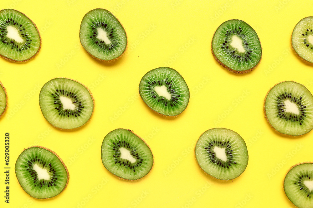 Fototapeta premium Slices of fresh kiwi on yellow background