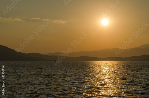 Evia island, Greece - July 01. 2020: Sunset on the island of Evia, Greece. Panoramic view of the sunset on the Greek island of Evia in the Aegean Sea.