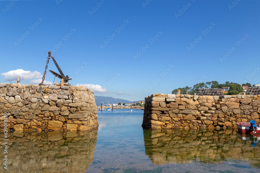 Nice entrance to the protected port of the fishing village of Cabo de Cruz. A Coruña, Galicia, Spain.