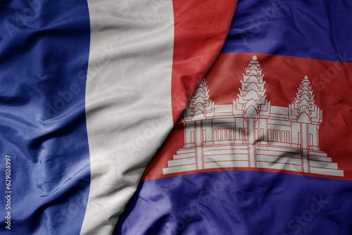 big waving realistic national colorful flag of france and national flag of cambodia .