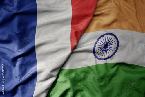 big waving realistic national colorful flag of france and national flag of india .
