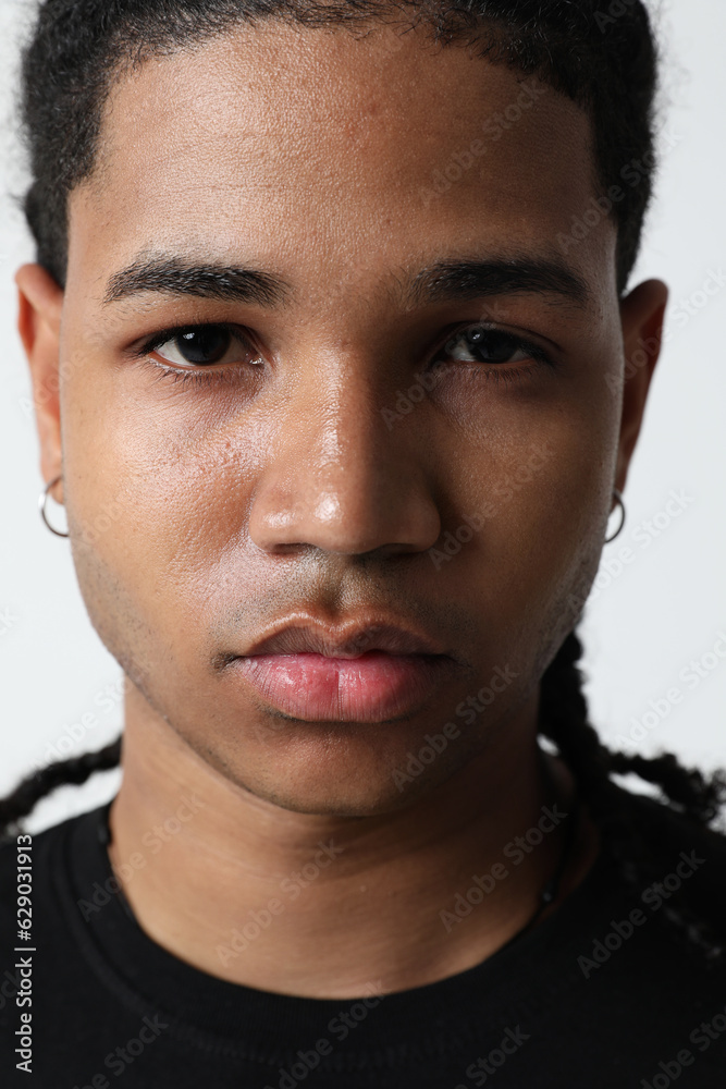 Fototapeta premium Close-up portrait of handsome dark-skinned young man posing in the studio.