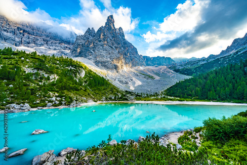 Beautiful view on turquoise Sorapis lake and with dito di dio in the background in the evening. Lake Sorapis, Dolomites, Belluno, Italy, Europe. © Michael