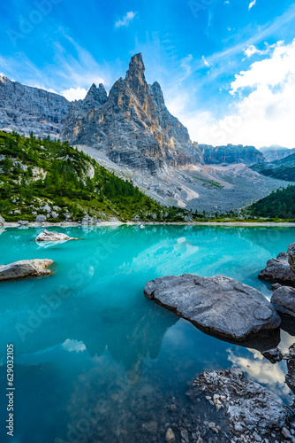 Mystic reflections on turquoise Sorapis lake with dito di dio in the background in the evening. Lake Sorapis, Dolomites, Belluno, Italy, Europe.