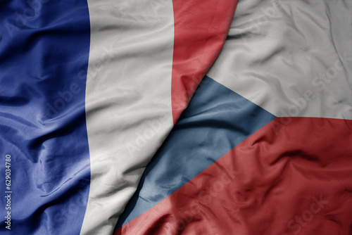 big waving realistic national colorful flag of france and national flag of czech republic .