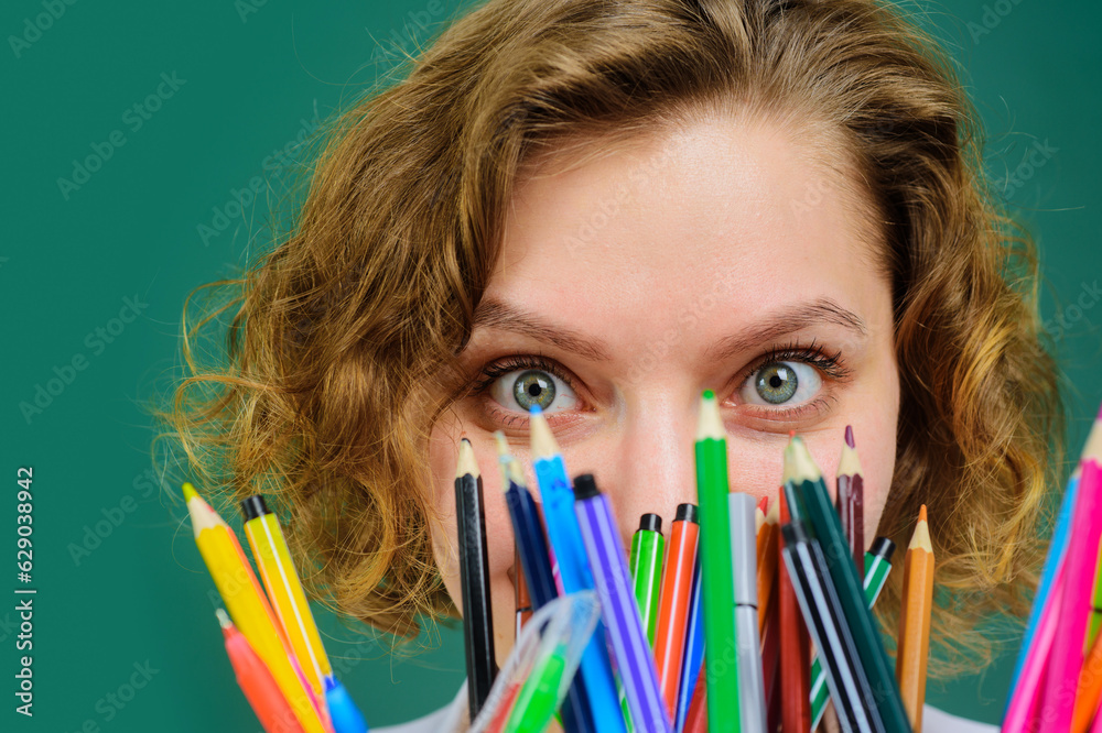 Back to school. Closeup portrait of female teacher with school office supplies. Pen. Pencils. Teacher in classroom with stationery supplies. Teachers day. Education, learning. School job. September 1. Back to school. Closeup portrait of female teacher with school office supplies. Pen. Pencils. Teacher in classroom with stationery supplies. Teachers day. Education, learning. School job. September 1.