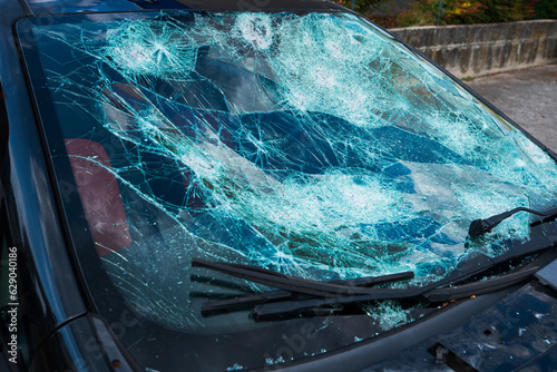 hail damage on car, with damaged windshield