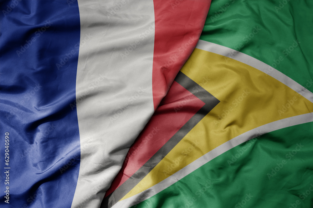 Obraz premium big waving realistic national colorful flag of france and national flag of guyana .