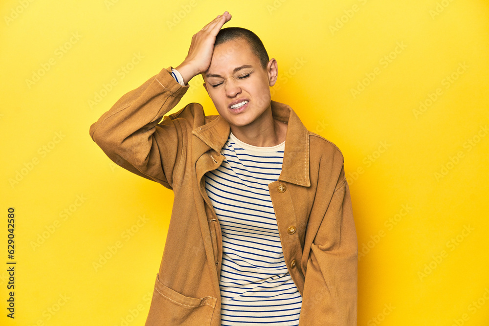 Woman in striped tee and denim shirt, yellow backdrop forgetting something, slapping forehead with palm and closing eyes. Woman in striped tee and denim shirt, yellow backdrop forgetting something, slapping forehead with palm and closing eyes.