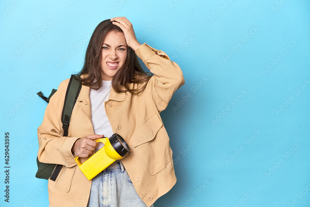 Adventurous woman with flashlight and backpack ready to explore being shocked, she has remembered important meeting. Adventurous woman with flashlight and backpack ready to explore being shocked, she has remembered important meeting.