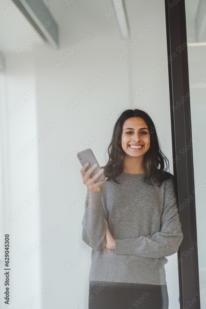Confident stylish indian business woman wearing casual clothes smiling and looking at camera