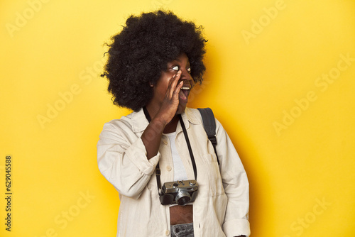 Stylish African-American woman with vintage camera Stylish African-American woman with vintage camera.shouting and holding palm near opened mouth.