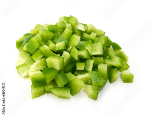 Sliced green bell pepper in a bowl on white background