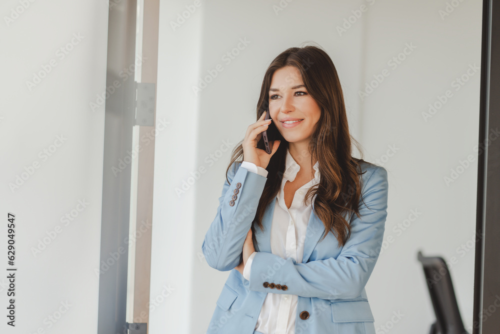 Beautiful, confident woman wearing formal clothes, stylish suit, talking on phone Beautiful, confident woman wearing formal clothes, stylish suit, talking on phone