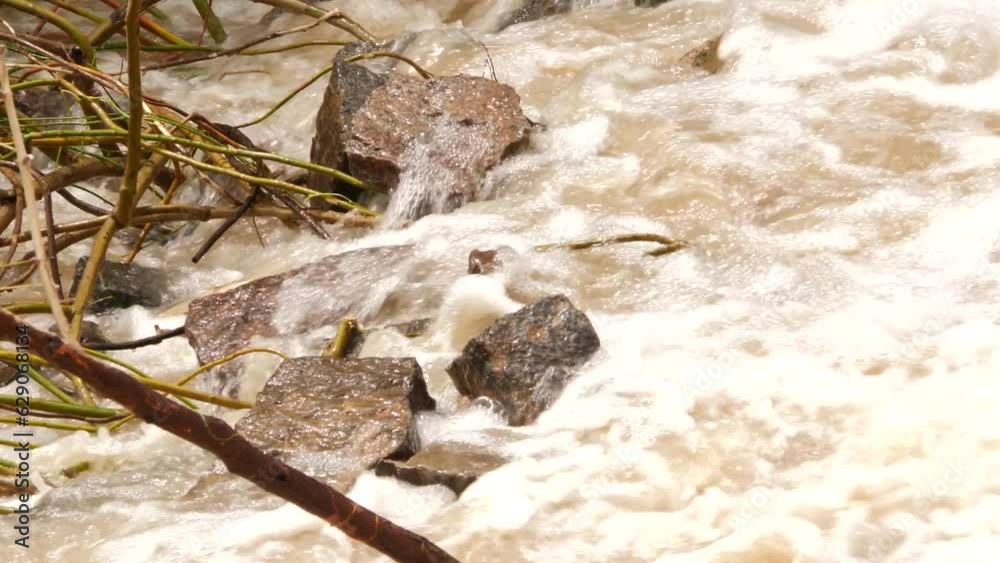 A river with rocks and water flowing over it, water rushing over rocks in a river A river with rocks and water flowing over it, water rushing over rocks in a river