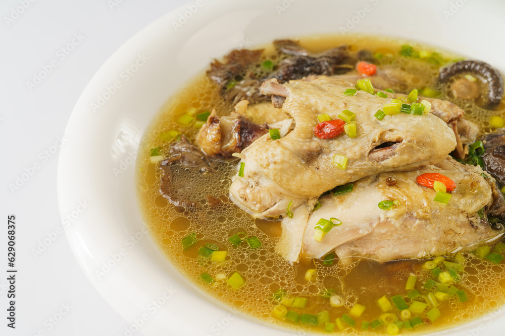 Special Chinese food stewed chicken with mushrooms on retro dark background Special Chinese food stewed chicken with mushrooms on retro dark background
