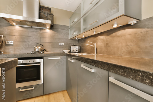 a modern kitchen with granite counter tops and stainless steel appliances on the wall behind it is a wood floor that has been used for
