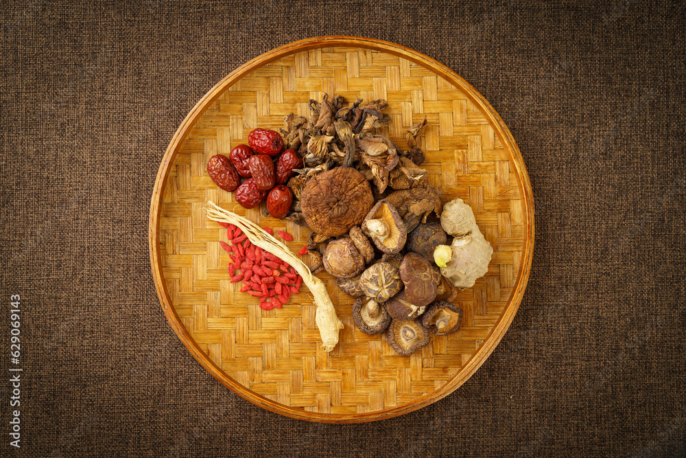 Variety of dried mountain delicacies placed in a bamboo woven tray on a monochrome background Variety of dried mountain delicacies placed in a bamboo woven tray on a monochrome background