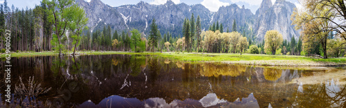 Fototapeta Naklejka Na Ścianę i Meble -  Panorama view of Mountains reflecting on flood water pond from Northside Drive in Yosemite Valley, Yosemite National Park, California, USA in May of 2023
