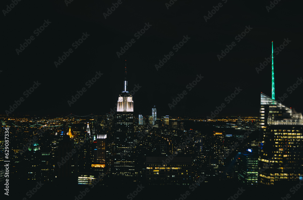 night photo of new york city taken from the top of the rock