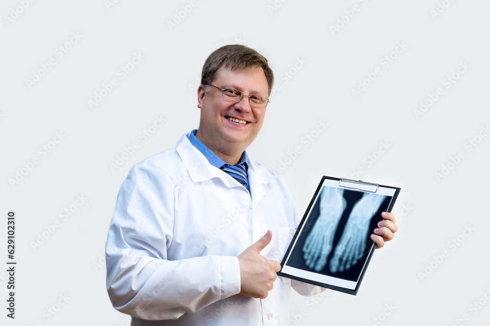 Male doctor examines an x-ray white gray background. Male doctor examines an x-ray white gray background.