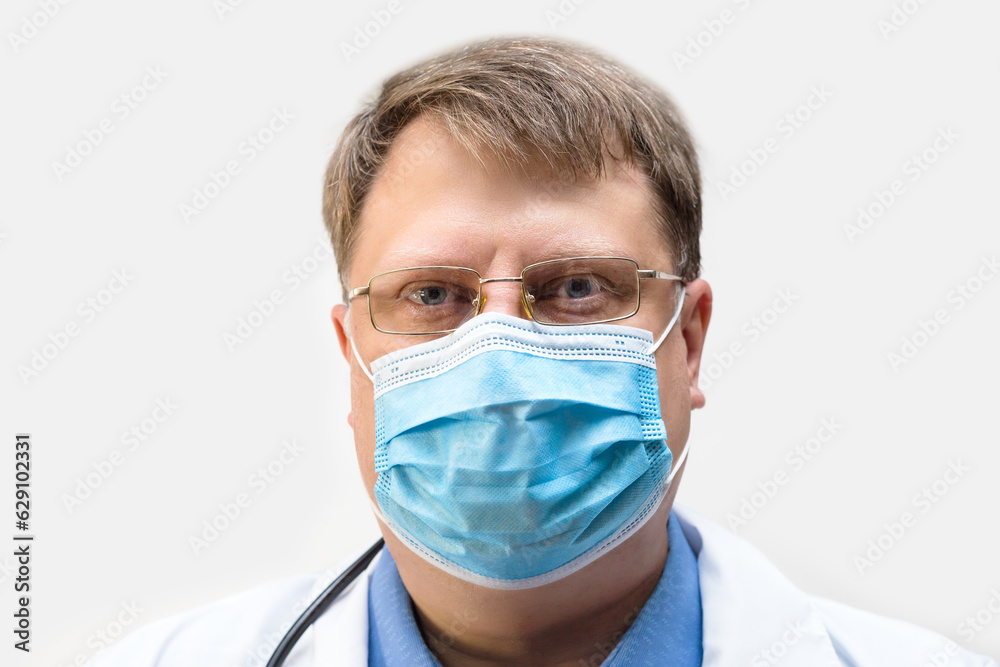 Portrait of a doctor in a protective mask on his face, close-up. Portrait of a doctor in a protective mask on his face, close-up.