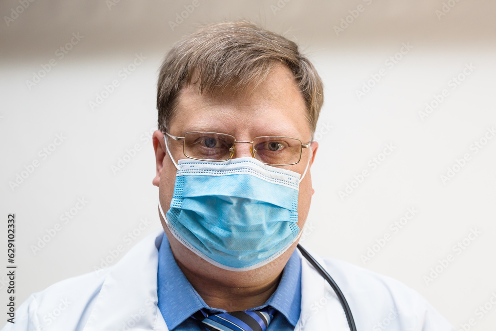 Portrait of a doctor protective mask on his face, close-up.
