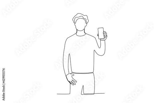 One continuous line drawing of a young man showing his cell phone casually facing forward
