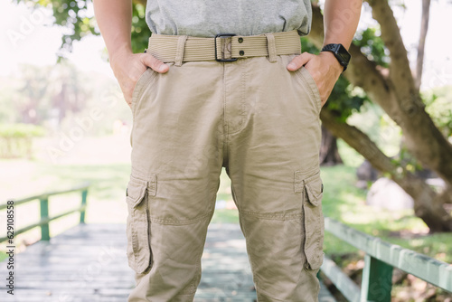 Model wearing yellow brown color cargo pants or cargo trousers