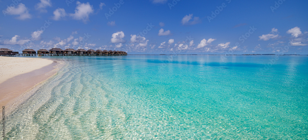 Amazing Maldives panorama. Luxury resort villas seascape. Closeup calm waves white sand blue sky clouds. Beautiful summer landscape. Amazing beach coast for travel vacation. Tropical paradise island