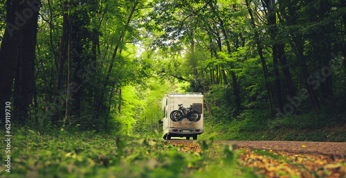 motor home in the forest- travel, vacation,adventure concept