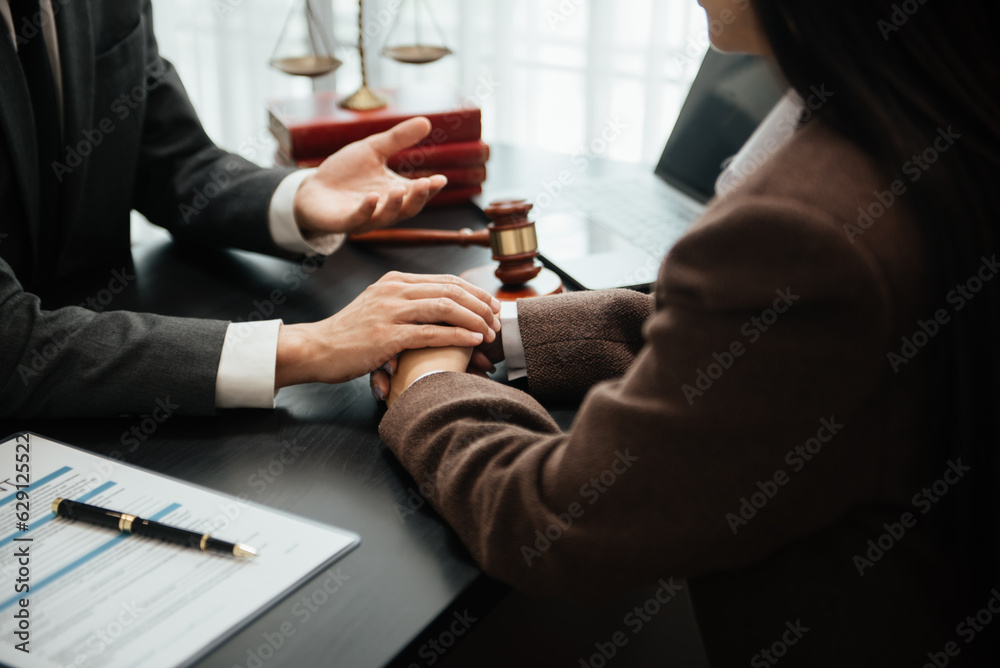 Judge gavel with scales of justice, Business and lawyer or counselor consulting and discussing contract papers with laptop and tablet at law firm