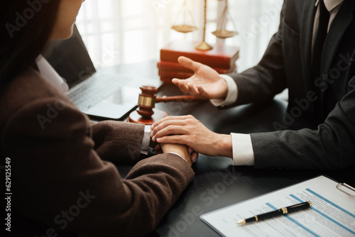 Judge gavel with scales of justice, Business and lawyer or counselor consulting and discussing contract papers with laptop and tablet at law firm