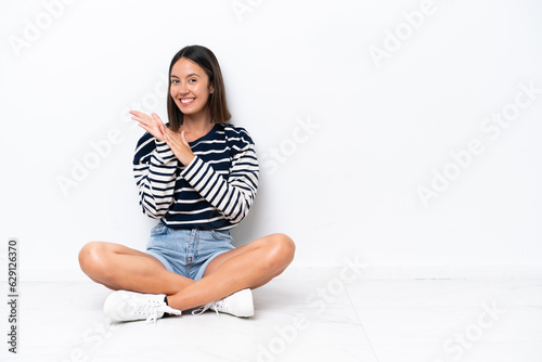 Wallpaper Mural Young caucasian woman sitting on the floor isolated on white background applauding after presentation in a conference Torontodigital.ca